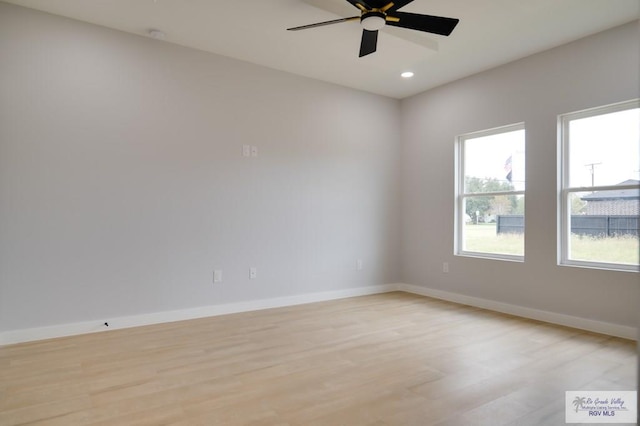 empty room featuring ceiling fan and light wood-type flooring