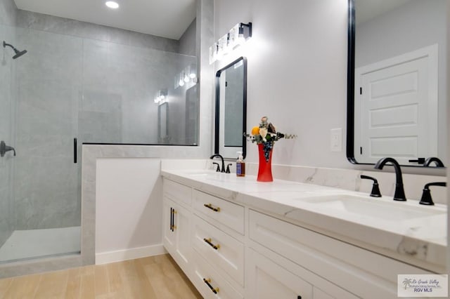 bathroom featuring vanity, wood-type flooring, and an enclosed shower