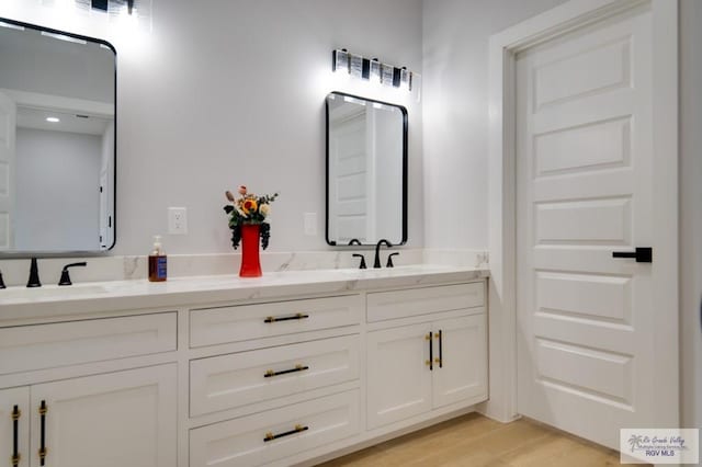 bathroom with hardwood / wood-style floors and vanity