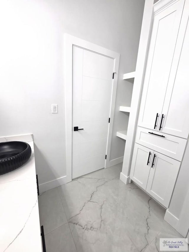121 Finch Dr, Los Fresnos, TX 78566 - bathroom with marble look tile flooring and baseboards