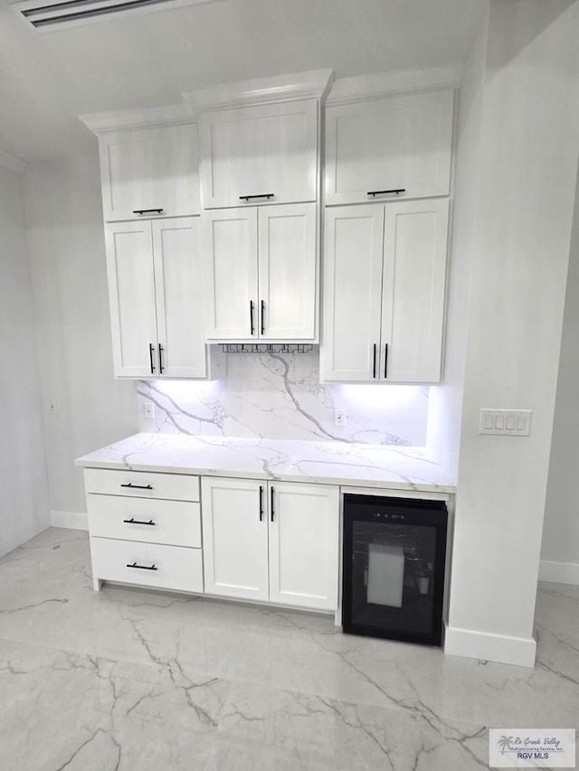 121 Finch Dr, Los Fresnos, TX 78566 - bar featuring light marble finish floors, wine cooler, and decorative backsplash