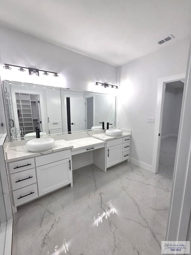 121 Finch Dr, Los Fresnos, TX 78566 - full bath with two vanities and marble finish flooring