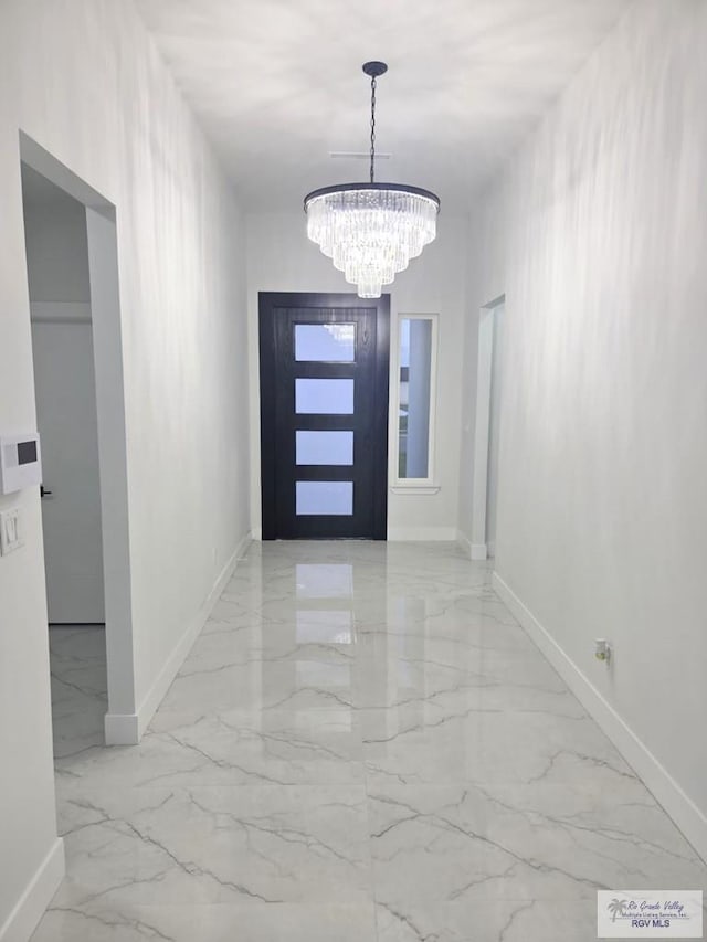121 Finch Dr, Los Fresnos, TX 78566 - foyer with marble tiled floors and a chandelier
