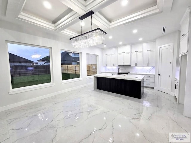 121 Finch Dr, Los Fresnos, TX 78566 - kitchen featuring light marble finish floors, a chandelier, light countertops, a center island with sink, and recessed lighting