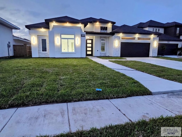 121 Finch Dr, Los Fresnos, TX 78566 - prairie-style house with an attached garage, driveway, stucco siding, and stone siding