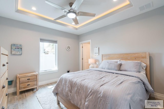 38 Spoonbill Cove Rd, Laguna Vista, TX 78578 - bedroom featuring a tray ceiling, baseboards, recessed lighting, light wood-style floors, and a ceiling fan