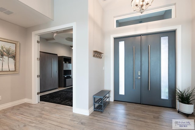 38 Spoonbill Cove Rd, Laguna Vista, TX 78578 - entryway with wood finished floors, baseboards, and a chandelier