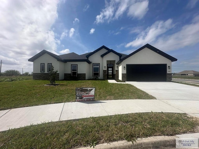 view of front facade with a front yard and a garage