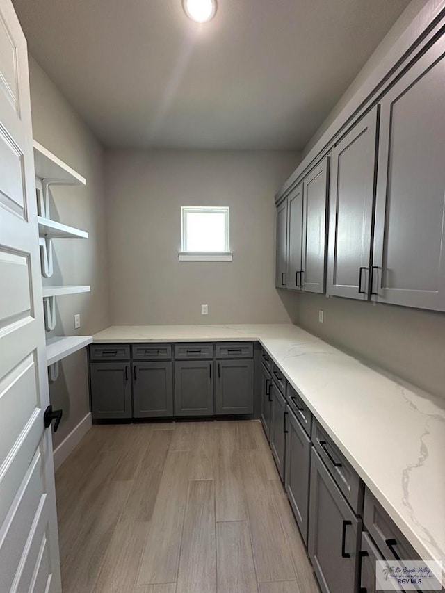 laundry room with light wood-type flooring