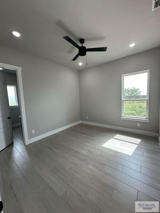 spare room with ceiling fan and light hardwood / wood-style flooring