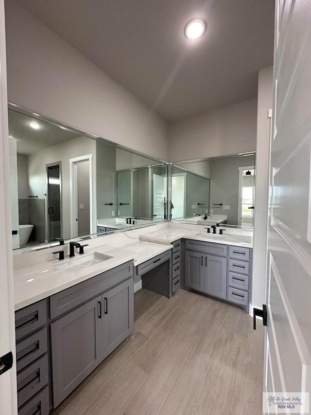 bathroom with vanity and a shower with shower door