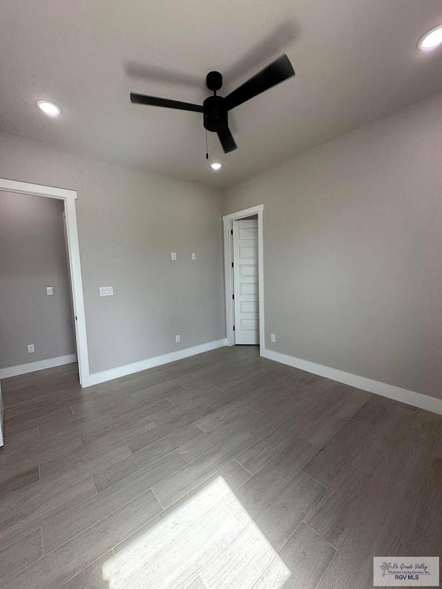 empty room featuring hardwood / wood-style flooring and ceiling fan