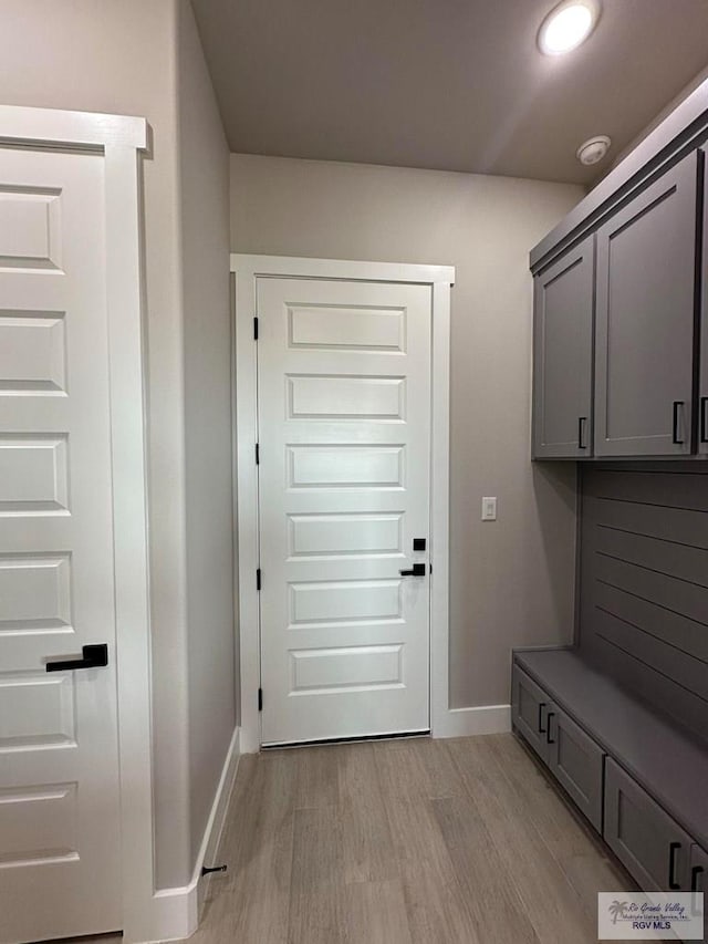 mudroom with light hardwood / wood-style flooring