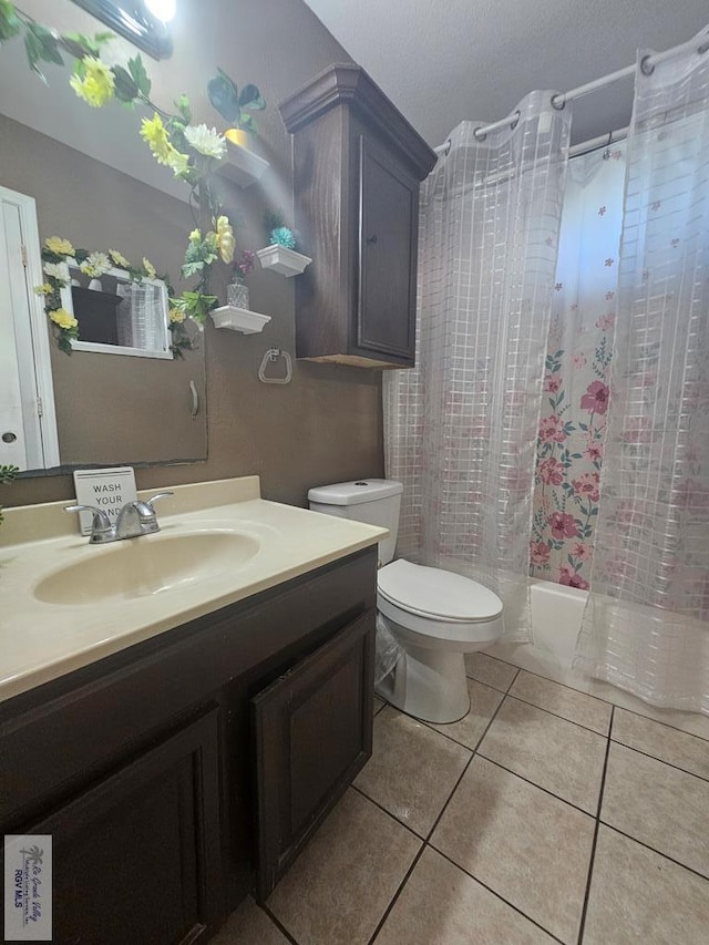 full bathroom with tile patterned floors, vanity, shower / bath combo, and toilet