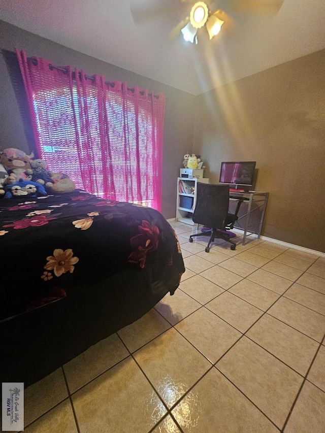 tiled bedroom featuring ceiling fan