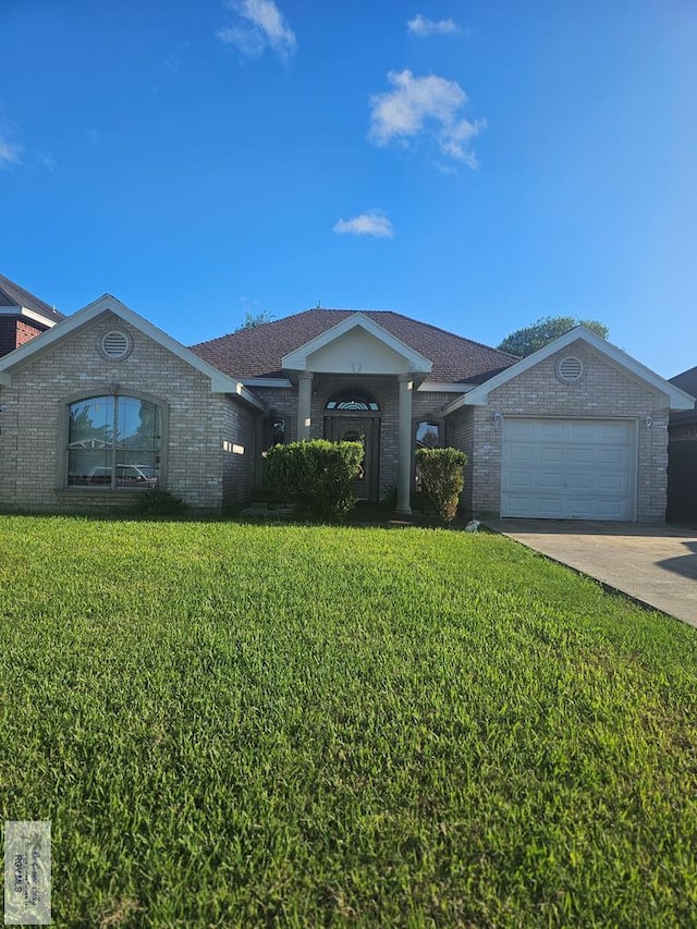 ranch-style home with a garage and a front lawn