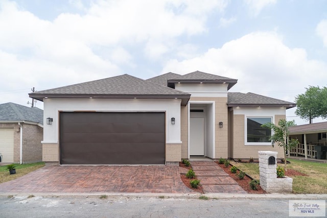 prairie-style home featuring a garage