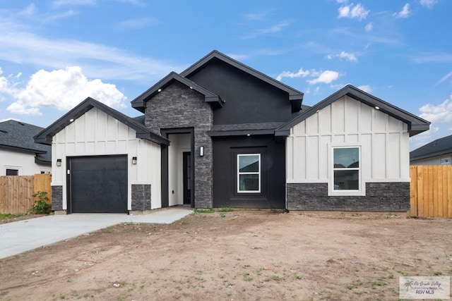 modern farmhouse style home with driveway, a garage, board and batten siding, and fence