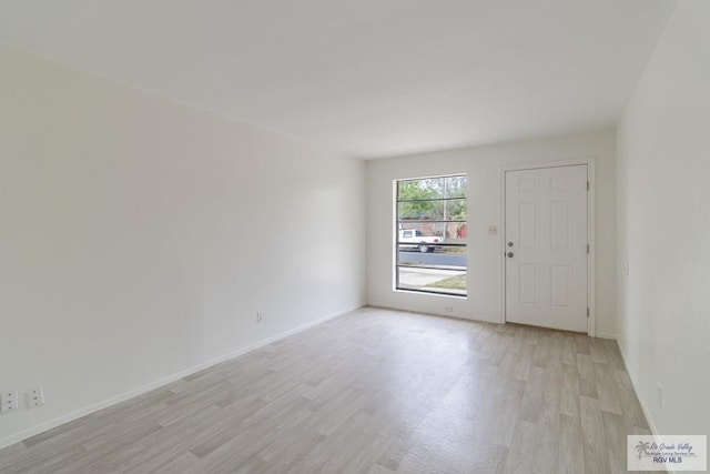 225 Chelo Dr, La Feria, TX 78559 - empty room with baseboards and light wood finished floors