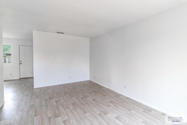 225 Chelo Dr, La Feria, TX 78559 - empty room with baseboards, visible vents, and light wood-style floors