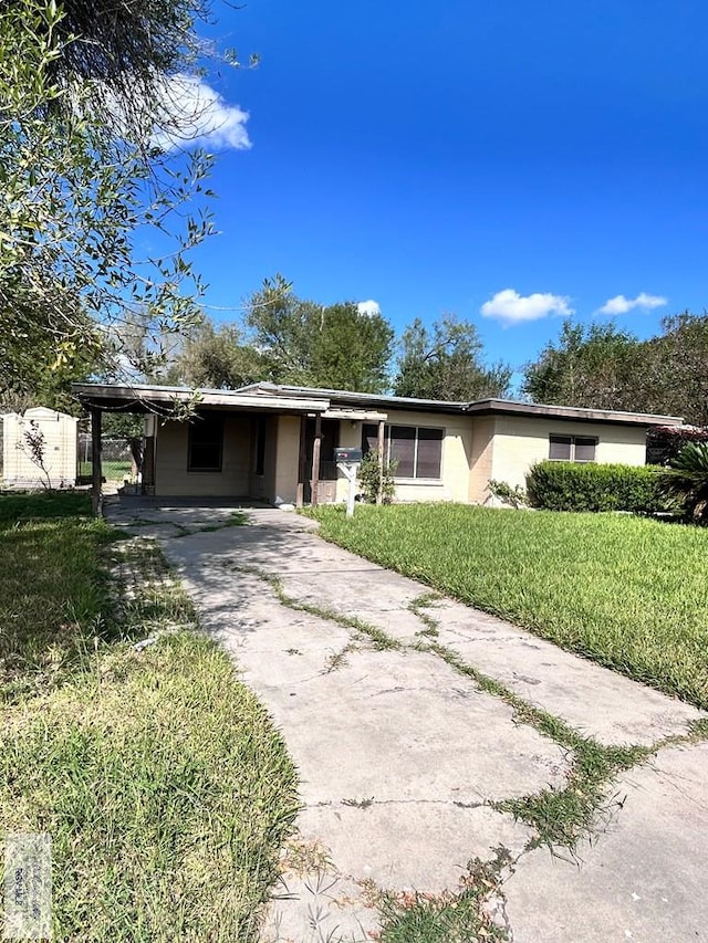 single story home with a front lawn and a carport