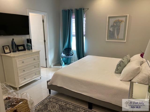 bedroom featuring light tile patterned flooring and multiple windows