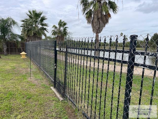 view of gate with a yard