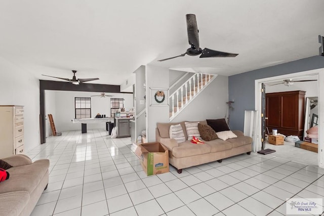 tiled living room with ceiling fan