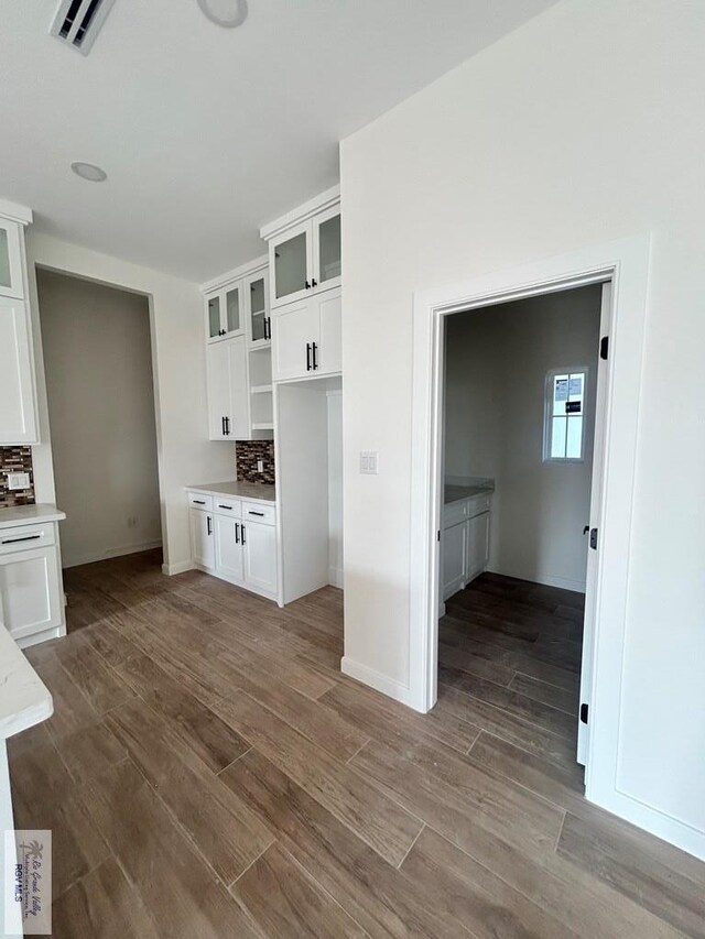 kitchen with glass insert cabinets and white cabinets