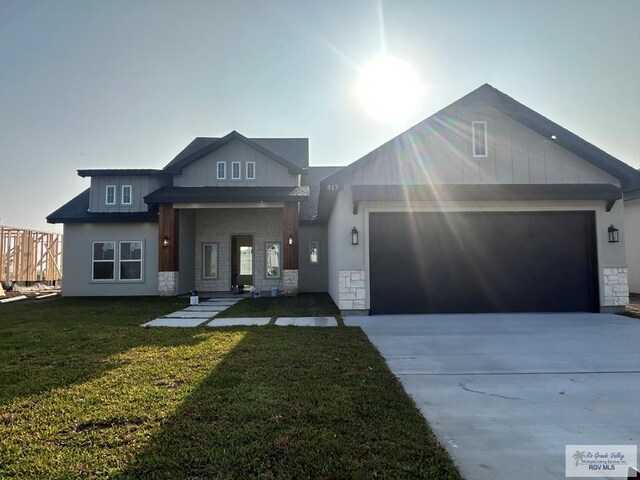 view of front of home with stone siding, concrete driveway, and an attached garage