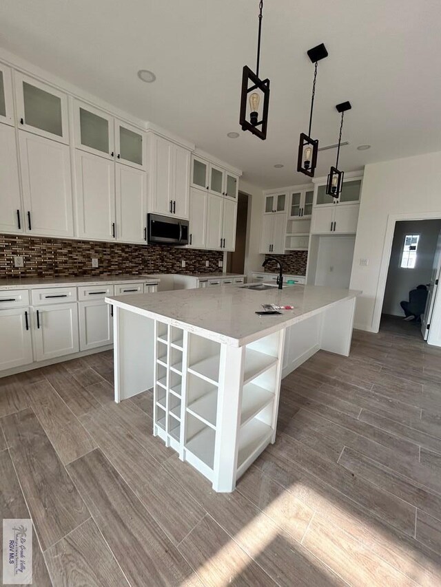 unfurnished room with beam ceiling, a high ceiling, coffered ceiling, and wood finished floors