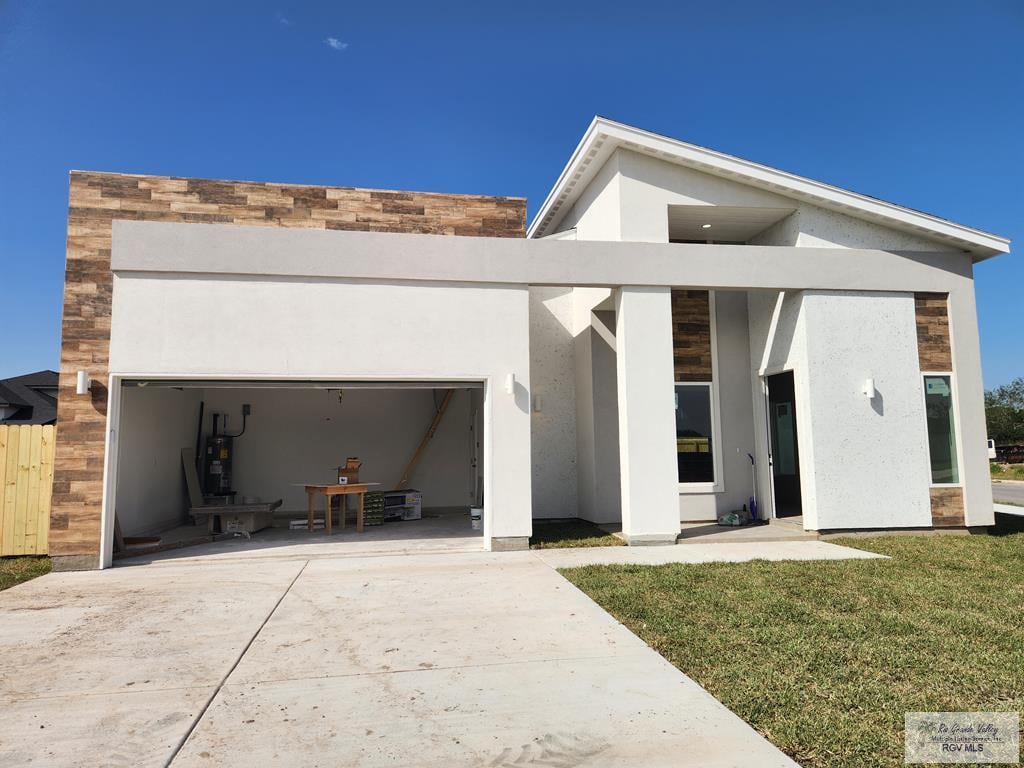 back of property with a yard and water heater