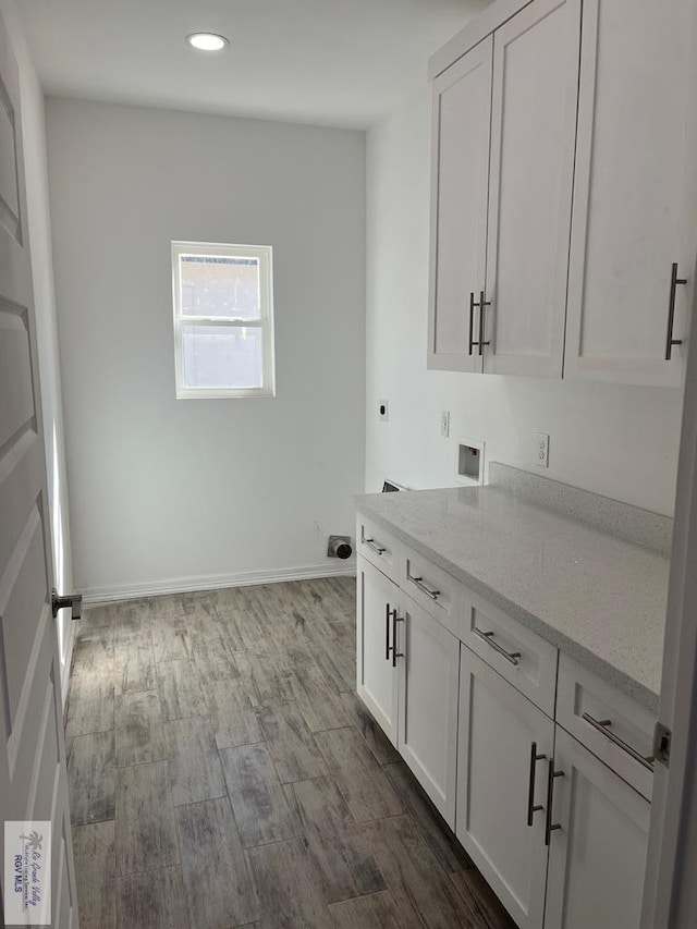 6214 Bentwood Dr, Harlingen, TX 78552 - washroom featuring hookup for an electric dryer, cabinet space, recessed lighting, washer hookup, and dark wood-style flooring