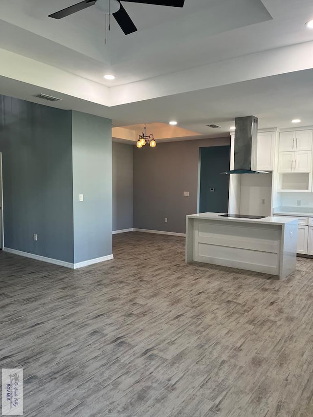 6214 Bentwood Dr, Harlingen, TX 78552 - unfurnished living room with wood finished floors, a raised ceiling, a ceiling fan, and recessed lighting