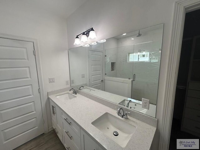 bathroom with vanity, wood-type flooring, and walk in shower