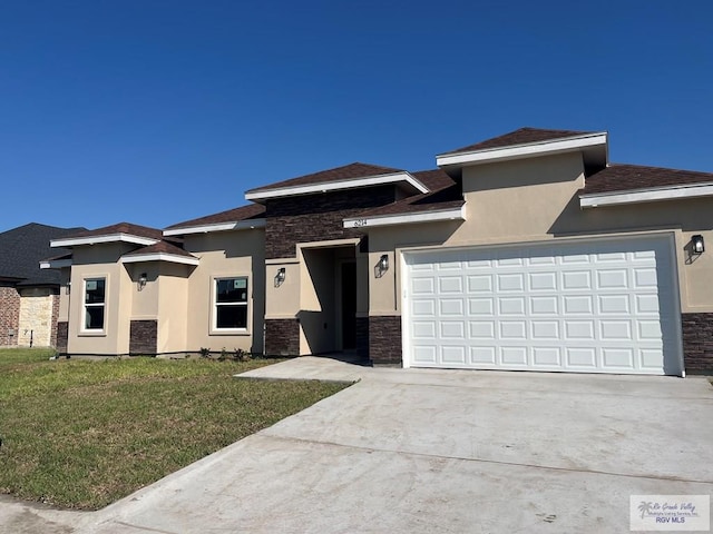 6214 Bentwood Dr, Harlingen, TX 78552 - prairie-style house featuring stone siding, stucco siding, concrete driveway, and a front yard
