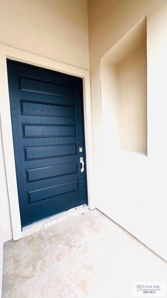 6214 Bentwood Dr, Harlingen, TX 78552 - property entrance with stucco siding