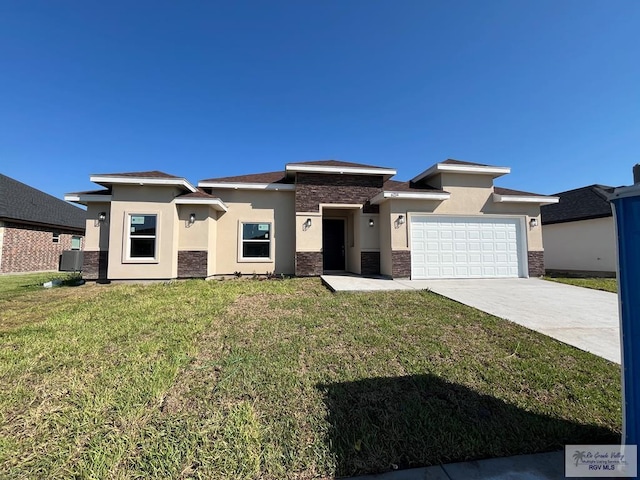6214 Bentwood Dr, Harlingen, TX 78552 - prairie-style home featuring stone siding, stucco siding, a garage, a front yard, and driveway