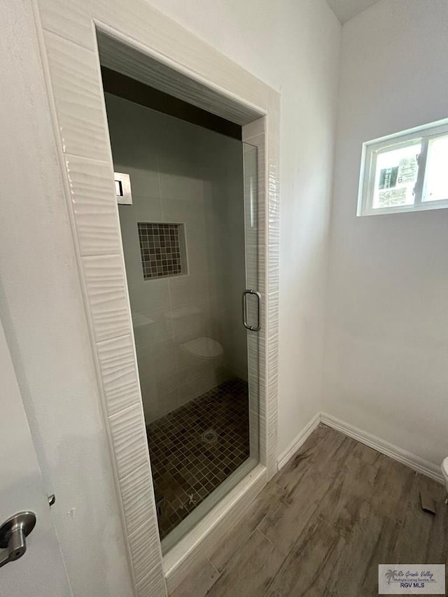 6214 Bentwood Dr, Harlingen, TX 78552 - bathroom with a stall shower and wood finished floors
