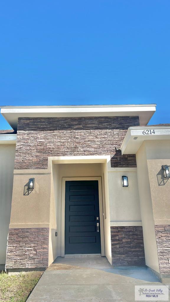 6214 Bentwood Dr, Harlingen, TX 78552 - property entrance featuring stone siding and stucco siding