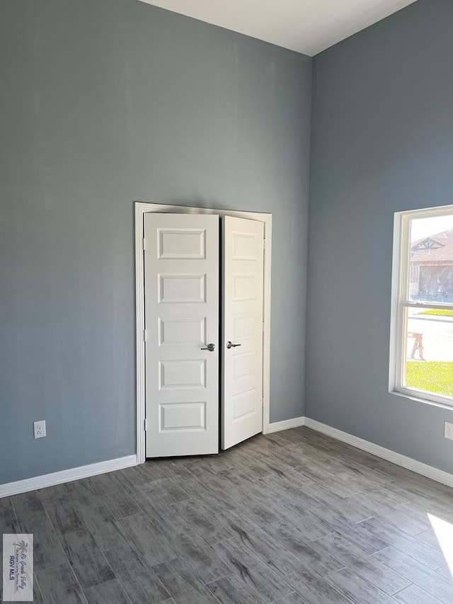 unfurnished bedroom with wood-type flooring and a closet