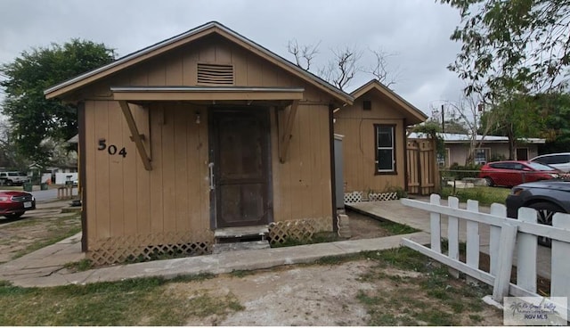 bungalow-style home featuring a shed