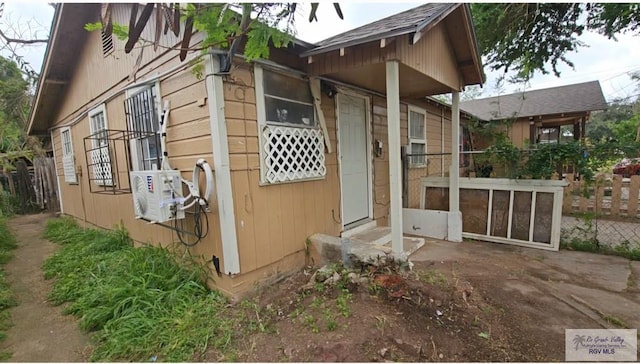 view of side of home with ac unit