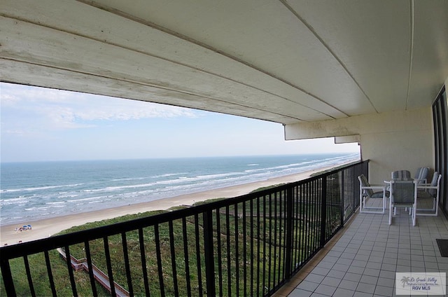 balcony with a beach view and a water view