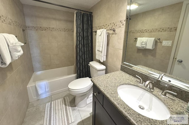 full bathroom featuring shower / bath combo, tile patterned floors, a textured ceiling, toilet, and vanity