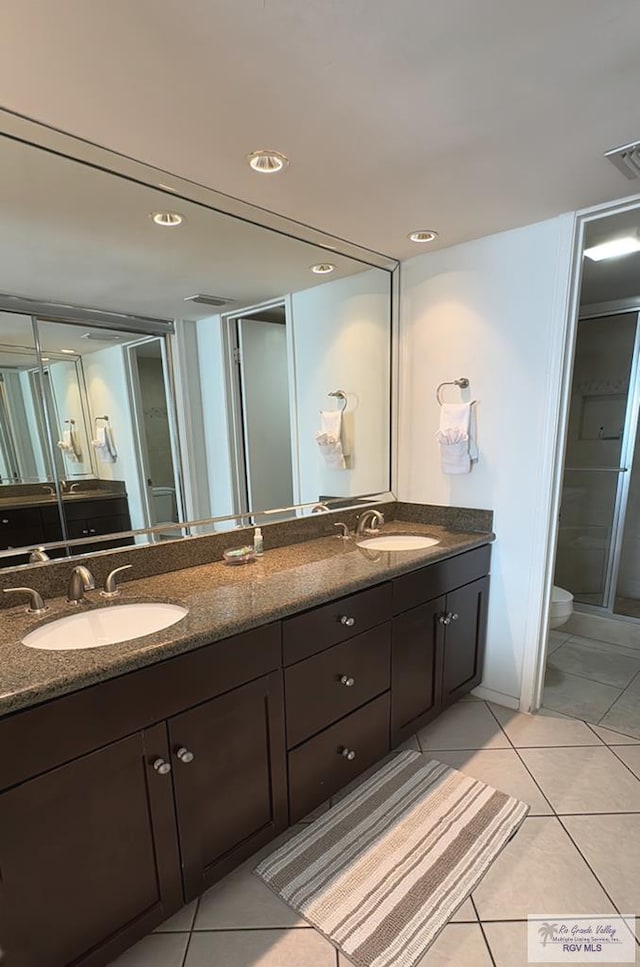 bathroom featuring tile patterned floors, vanity, and toilet