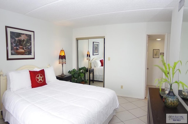 tiled bedroom featuring a closet