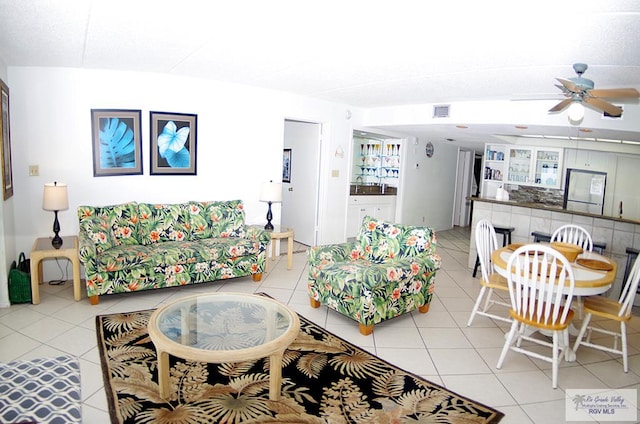 living room featuring ceiling fan and light tile patterned flooring