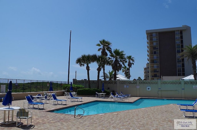 view of swimming pool featuring a patio area