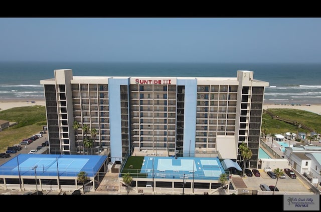 view of property featuring a water view and a view of the beach